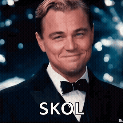 A Man In A Tuxedo And Bow Tie Is Smiling And The Word Skol Is On The Bottom Right GIF
