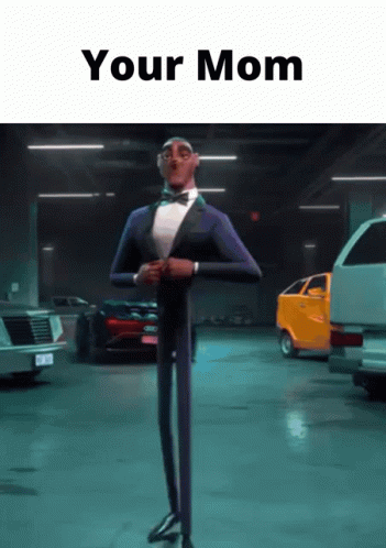 A Man In A Tuxedo And Bow Tie Is Standing In A Garage With The Words " Your Mom " Written Above Him GIF