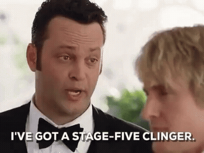 A Man In A Tuxedo And Bow Tie Is Talking To A Woman In A Suit . GIF
