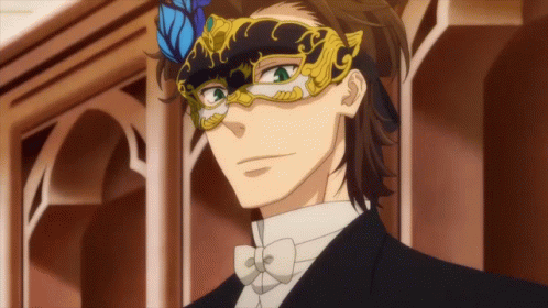 A Man In A Tuxedo And Bow Tie Is Wearing A Masquerade Mask GIF