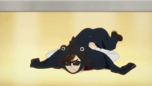 A Man In A Tuxedo And Frog Hat Is Laying On The Ground GIF
