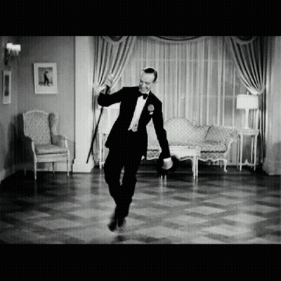 A Man In A Tuxedo Dancing In A Living Room GIF