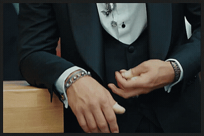 A Man In A Tuxedo Has A Bracelet On His Left Wrist GIF