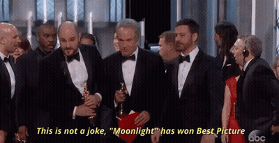 A Man In A Tuxedo Holding An Oscar Says " This Is Not A Joke Moonlight Has Won Best Picture " GIF
