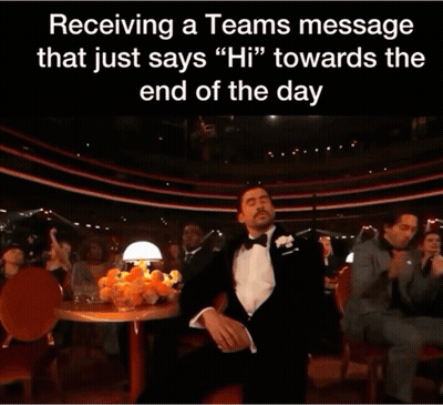 A Man In A Tuxedo Holds His Hand To His Face In Front Of A Crowd GIF