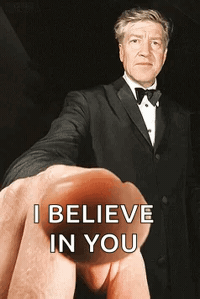 A Man In A Tuxedo Is Being Held Up By A Finger That Says I Believe In You GIF