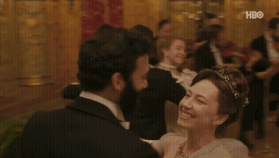 A Man In A Tuxedo Is Dancing With A Woman In A White Dress With A Hbo Logo In The Background . GIF