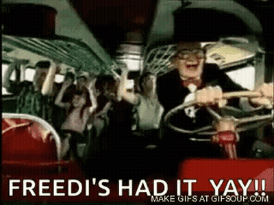 A Man In A Tuxedo Is Driving A Bus With A Crowd Of People On It . GIF