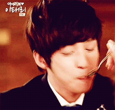 A Man In A Tuxedo Is Eating Something With A Fork And Spoon GIF
