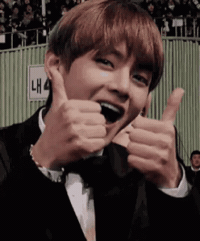 A Man In A Tuxedo Is Giving A Thumbs Up Sign . GIF