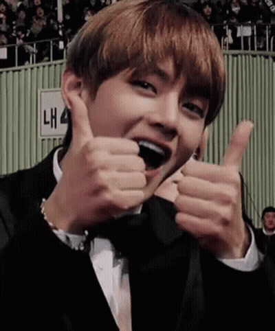A Man In A Tuxedo Is Giving Two Thumbs Up . GIF