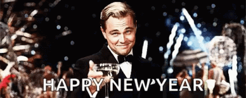 A Man In A Tuxedo Is Holding A Glass Of Champagne With The Words Happy New Year Written Below Him GIF