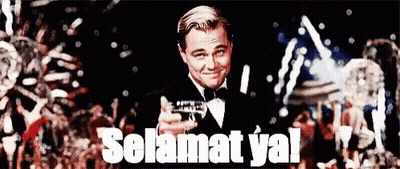 A Man In A Tuxedo Is Holding A Gun And Says Selamat Ya GIF
