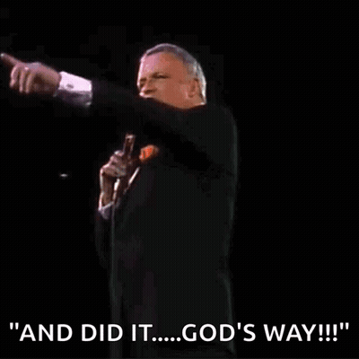 A Man In A Tuxedo Is Holding A Microphone And Saying " And Did It ... God 'S Way " GIF