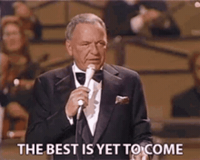 A Man In A Tuxedo Is Holding A Microphone And Saying The Best Is Yet To Come GIF