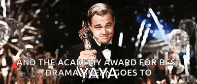 A Man In A Tuxedo Is Holding An Oscar Trophy With The Words " And The Academy Award For Best Drama " Written Below Him GIF