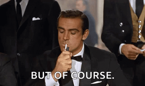 A Man In A Tuxedo Is Lighting A Cigarette With The Words But Of Course Behind Him GIF