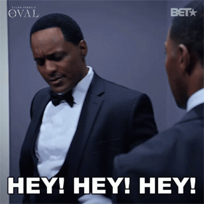 A Man In A Tuxedo Is Looking At Himself In The Mirror And Says Hey Hey Hey GIF