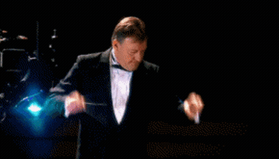 A Man In A Tuxedo Is Pointing At The Word Banned In Red GIF
