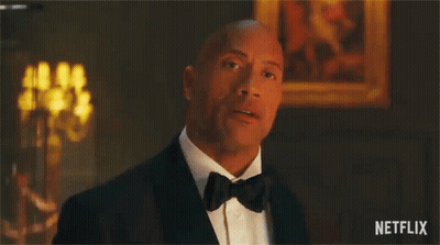 A Man In A Tuxedo Is Saying `` You 'Re Under Arrest '' In A Room . GIF