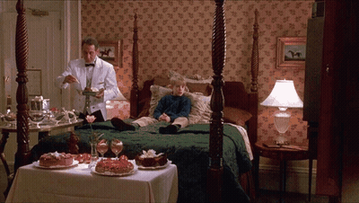 A Man In A Tuxedo Is Serving A Dessert To A Boy In A Hotel Room GIF