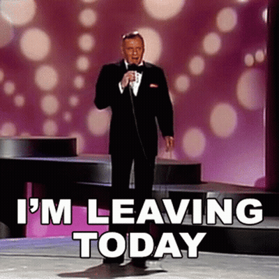 A Man In A Tuxedo Is Singing Into A Microphone With The Words " I 'M Leaving Today " Behind Him GIF