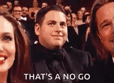 A Man In A Tuxedo Is Sitting In A Crowd With A Woman And A Man . GIF