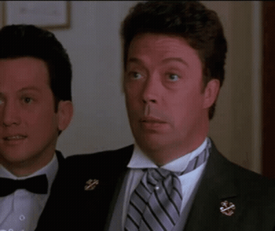 a man in a tuxedo is smiling and says i love you