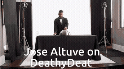 A Man In A Tuxedo Is Standing Behind A Table With The Words Jose Altuve On Deathy Deat Written On It GIF
