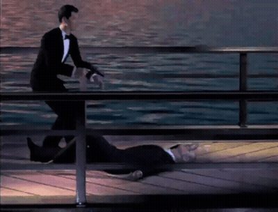 A Man In A Tuxedo Is Standing Next To A Dead Man On A Pier GIF