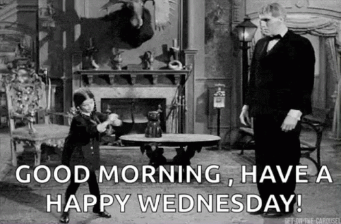 A Man In A Tuxedo Is Standing Next To A Little Boy In A Room . GIF