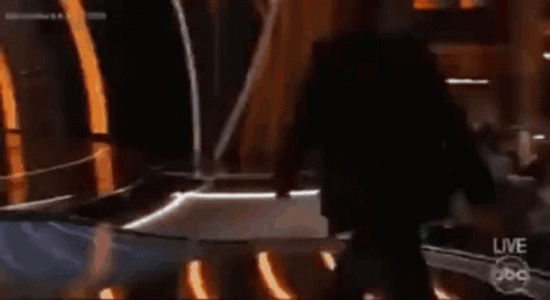 A Man In A Tuxedo Is Standing On A Stage With A Live Abc Logo GIF