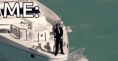 A Man In A Tuxedo Is Standing On The Side Of A Boat With The Word Me Above Him . GIF