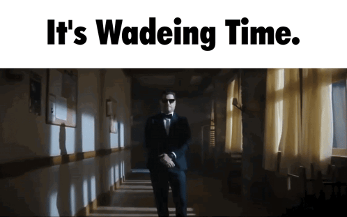 A Man In A Tuxedo Is Walking Down A Hallway With The Words " It 'S Wadeing Time " GIF