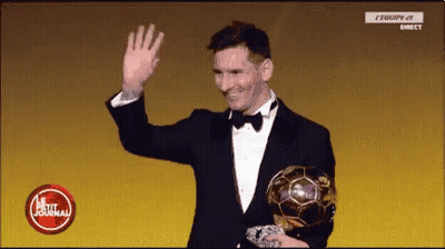 A Man In A Tuxedo Is Waving While Holding A Soccer Ball GIF