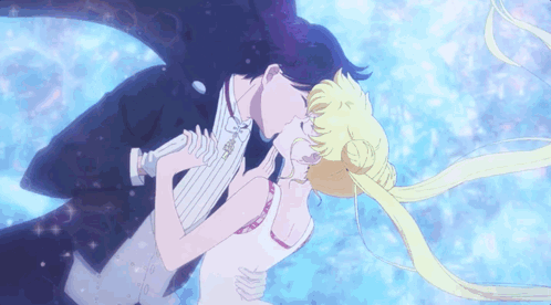 A Man In A Tuxedo Kissing A Woman In A Dress GIF