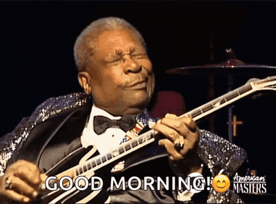 A Man In A Tuxedo Playing A Guitar With The Words Good Morning On The Bottom GIF