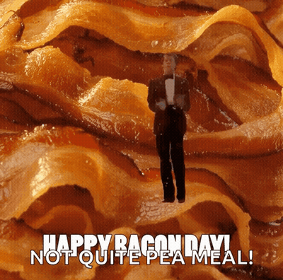 A Man In A Tuxedo Stands In A Pile Of Bacon GIF