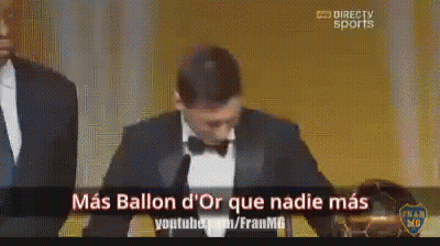 A Man In A Tuxedo Stands In Front Of A Microphone With The Words Mas Ballon D' Or Que Nadie Mas On The Bottom GIF