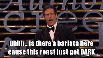 A Man In A Tuxedo Stands In Front Of A Sign That Says ' Uhh ' GIF