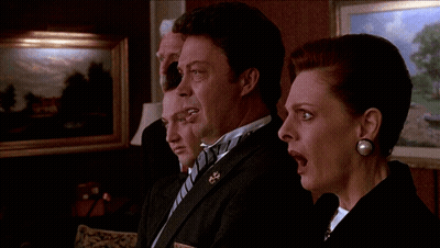 A Man In A Tuxedo Stands Next To A Woman GIF