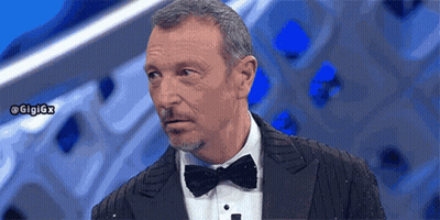 A Man In A Tuxedo With A Bow Tie Has The Hashtag Gigigx On The Bottom Right GIF