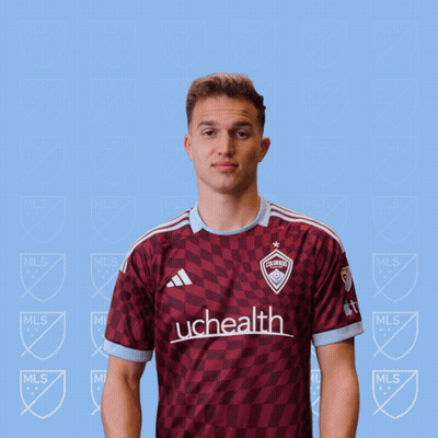 A Man In A Uchealth Jersey Holds A Red Card GIF