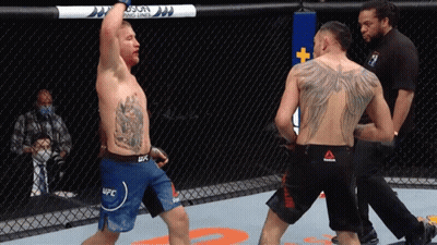 A Man In A Ufc Shorts Stands In A Boxing Ring GIF