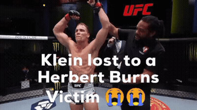 A Man In A Ufc Shorts Stands In A Cage GIF