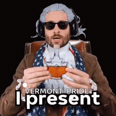 A Man In A Vermont Pride Costume Is Holding A Glass GIF