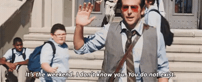 A Man In A Vest And Tie Is Waving At A Group Of Children While Standing On A Set Of Stairs . GIF