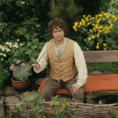 A Man In A Vest Is Sitting On A Bench Holding A Sword GIF