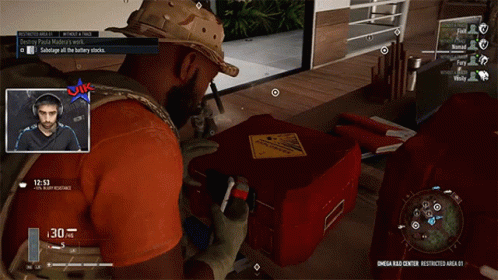 A Man In A Video Game Is Looking At A Red Box With A Yellow Warning Sign On It GIF