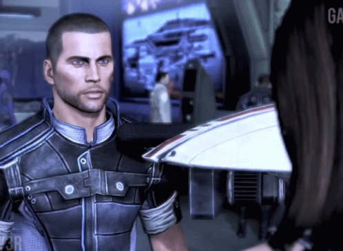 A Man In A Video Game Is Standing Next To A Woman With The Word Ga On The Bottom Right GIF